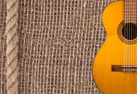 Classical guitar on the background of burlap