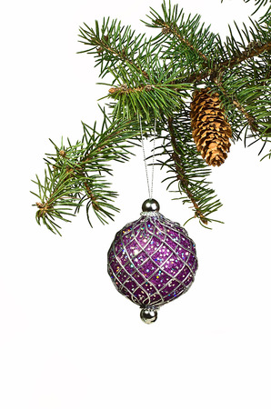 Spruce branch with cones and Christmas toys on a white backgroundの写真素材