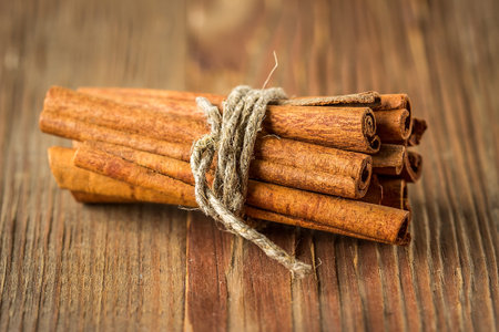 Bunch of cinnamon sticks tied with twine, selective focus
