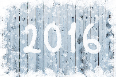 Wooden board with snow flakes. Christmas background with an inscriptionの写真素材