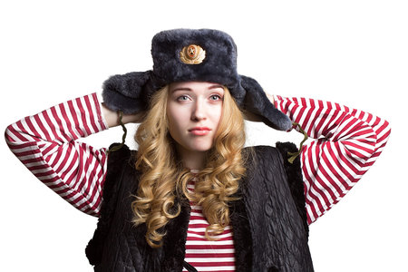 Portrait of a girl in a soldier's cap  on white backgroundの写真素材