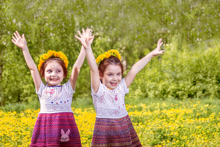 Two adorable girls  playing on the meadow in summer dayの写真素材