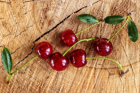 Fresh red Cherries on wooden table macro backgroundの写真素材