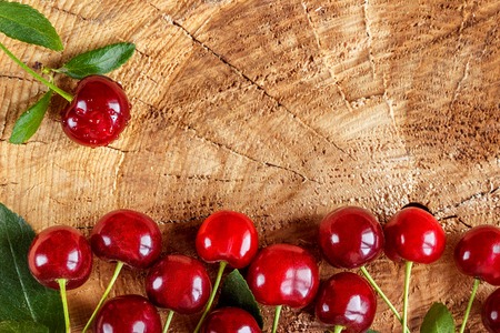Cherries on wooden table. Can be used as backgroundの写真素材