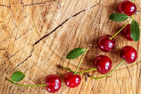 Fresh red Cherries on wooden table macro background