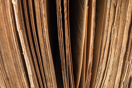 Very Old Book closeup. Texture of the old cracked cardboard cover of the bookの写真素材