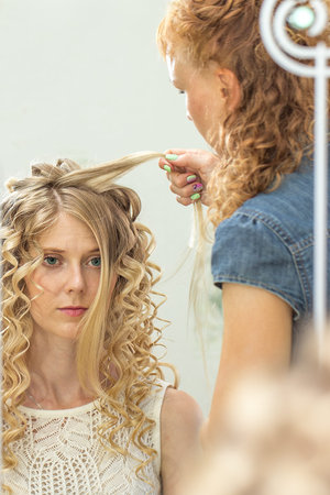 Hair stylist makes the bride before wedding. Wedding hairstyle1の写真素材