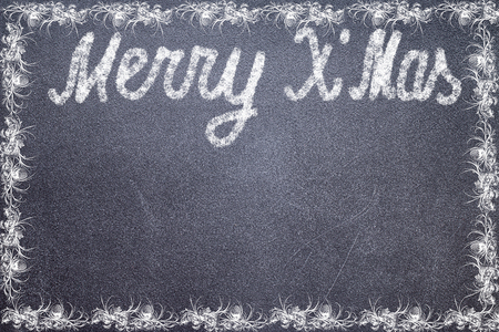 Merry Christmas written in white chalk on a black chalkboard isolated on whiteの写真素材