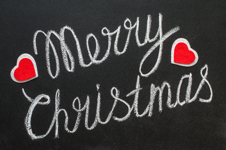 Merry Christmas text written on chalkboard isolated on whiteの写真素材