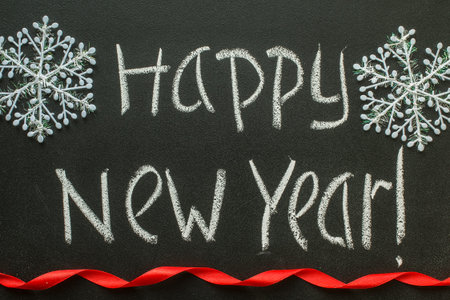 Happy New Year message greeting handwriting on a blackboardの写真素材