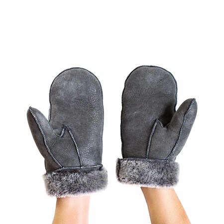 Hands in gloves with natural fur on white backgroundの写真素材