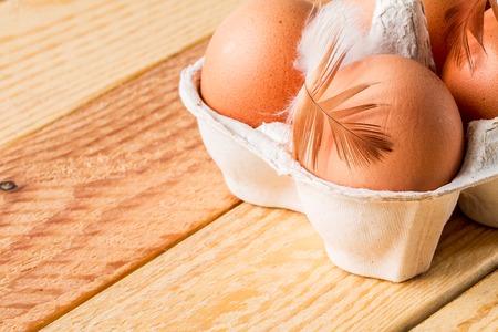 Brown eggs in box on wooden table .  eggs in a carton packageの写真素材