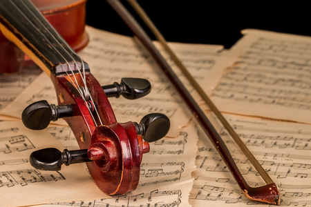 violin lying on the sheet of musicの写真素材