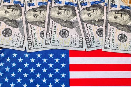 American dollars over the flag of the United States