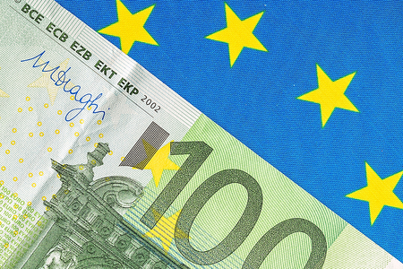 EU flag and many euro banknotesの写真素材