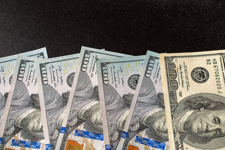 Pile of dollar bills on blackboard background