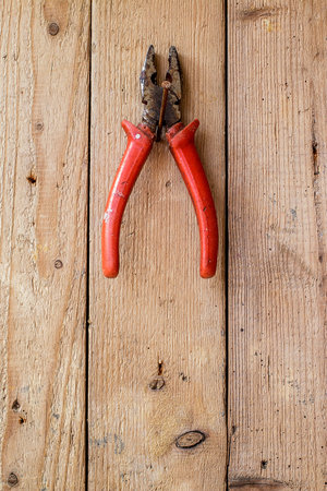 Old  pliers on a wooden wall