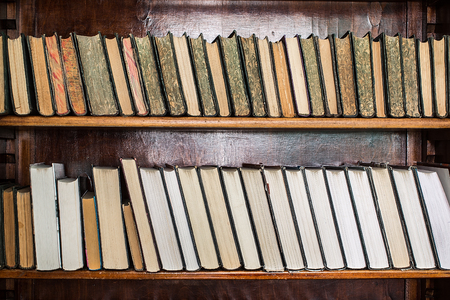 old books on an archival shelf of library of storehouseの写真素材