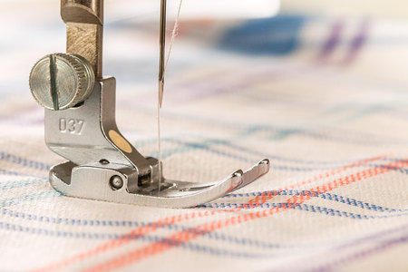 Closeup of sewing machine and fabric. Empty space for text 
