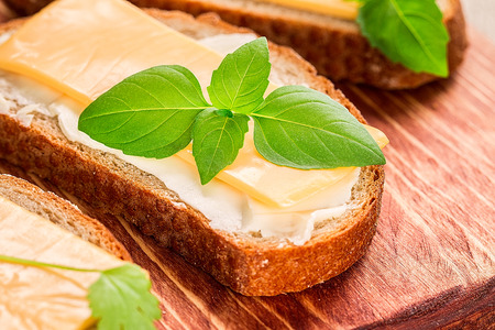 Butter and bread for breakfast, with parsley over rustic wooden backgroundの写真素材