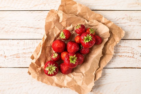 Ripe red strawberries  on old rustic wooden table. Healthy food concept. Flat layの写真素材