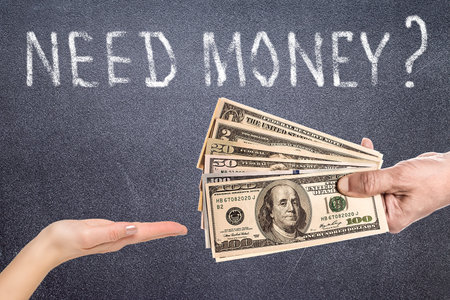 Male hand squeezing tightly some banknotes