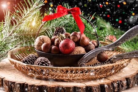 Christmas Christmas composition with pine cones, nuts and a Christmas tree on rustic wooden backgroundの写真素材