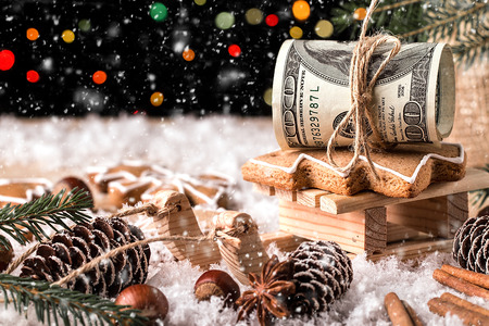 Money Christmas  Gift with wooden sled. Christmas and New Year conceptの写真素材