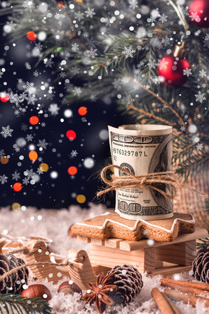 Money Christmas  Gift with wooden sled. Christmas and New Year conceptの写真素材