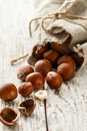 Hazelnut heap on wooden table, selective focusの写真素材