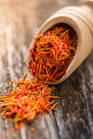 Saffron  seasoning in a wooden spoon close up.の写真素材