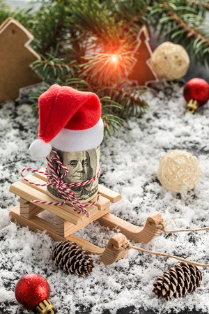 Money Christmas Gift and snowflakes on Wooden Table. Basket, red balls, pine cones, snowflakes on Wooden Table. Christmas and new year conceptの写真素材