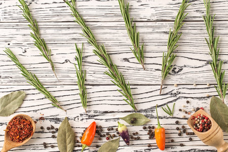 background rosemary, chili pepper on a wooden table. Herb and spice ingredients on  wooden white backgroundの写真素材