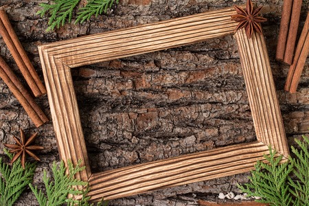 Christmas decoration on the white wooden background. Christmas interior with photo frame, decorative branches, presents on wooden table. New Year winter composition. Top View. Space for textの写真素材
