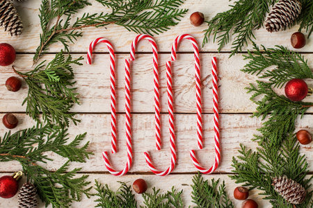 Frame made of festive Christmas decor and fir branches on wooden background. New Year and Christmas...