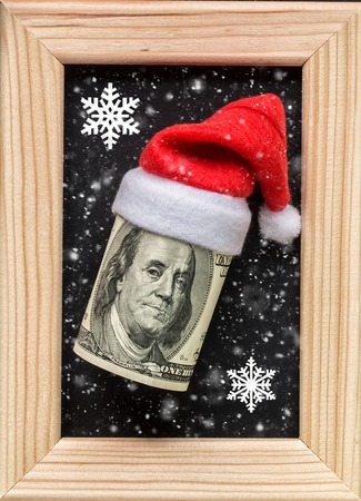 Dollars on wooden photo frame.  Winter holidays concept.の写真素材