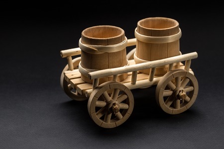 Wooden Toy Cart on White Background. Antique wooden farmers cart for agriculture purposeの写真素材