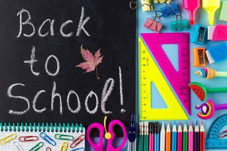 Back to School Text. School Stationary and Blackboard. Creative flat lay back to school. Composition with different school stationery on color background, Top viewの写真素材