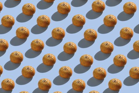 Creative pattern pumpkin on blue background. Minimal food concept. Seamless patternの写真素材