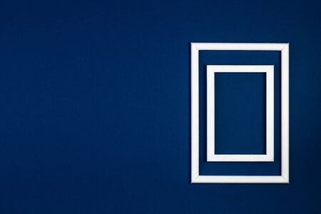 Empty wooden picture frame on a blue classic backgroundの写真素材