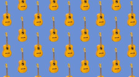 Pattern seamless acoustic guitar on blue background. Pattern with instrument for music. Minimalistic concept of music. guitar printの写真素材