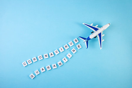 Plane with the words quarantine and coronavirus written on a blue background. Pandemic Covid-19...