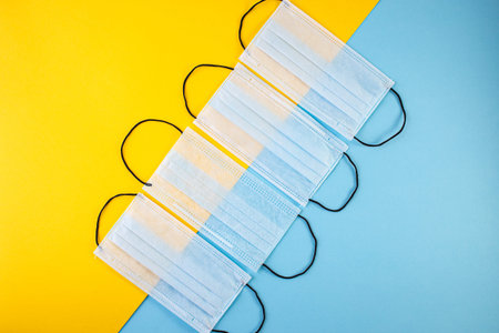 Medical mask, Medical protective masks on blue and yellow background. Prevent coronavirus. Prevent...