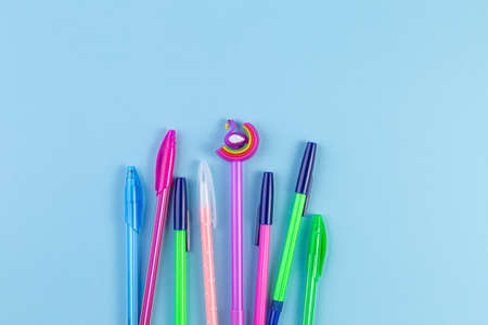 Set of colored pens on blue paper background with copy space.の写真素材