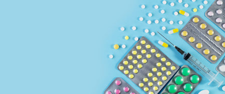 Medical banner with space for text. Pills and capsules on a blue background.の写真素材