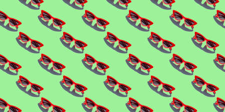 Red sunglasses seamless pattern on Green background. Concept of minimalist summer vacation and UV protection.の写真素材