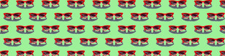 Red sunglasses seamless pattern on Green background. Concept of minimalist summer vacation and UV protection.の写真素材
