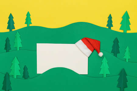 Christmas tree paper cutting design papercraft card with Santa Claus hat. Paper cut Christmas trees.の写真素材