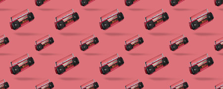 Seamless pattern with Vintage radio cassette recorder isolated over pink background. Old retro red radio and cassette player. retro technology. Long wide bannerの写真素材
