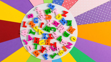 Back to school Education concept. Bright multicolored alphabet background. Multicolored wooden...